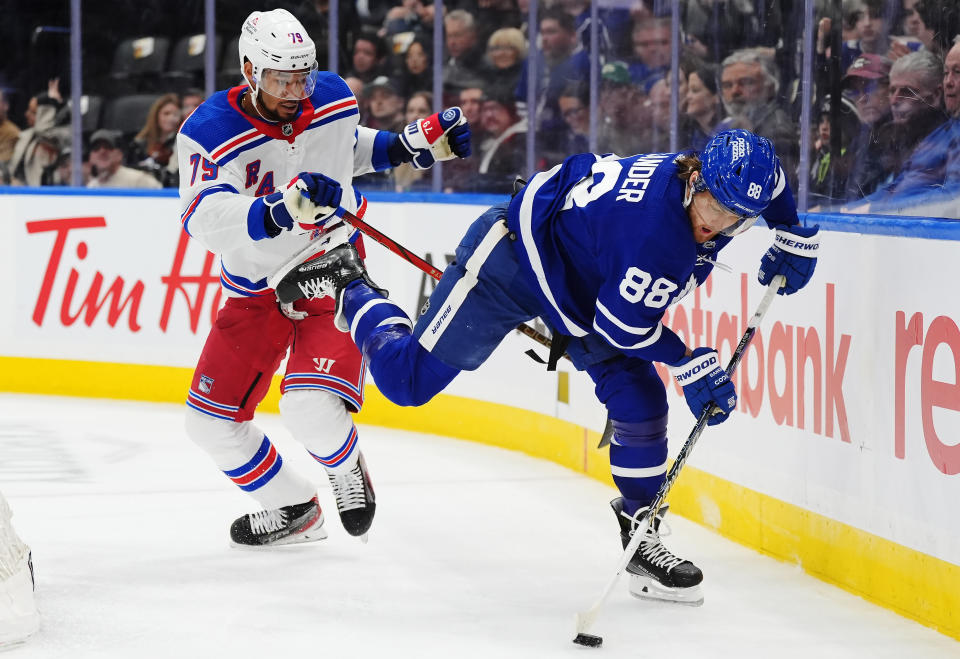 Toronto Maple Leafs' William Nylander (88) stumbles as New York Rangers' K'Andre Miller (79) looks on during the second period of an NHL hockey game in Toronto on Saturday, March 2, 2024. (Frank Gunn/The Canadian Press via AP)