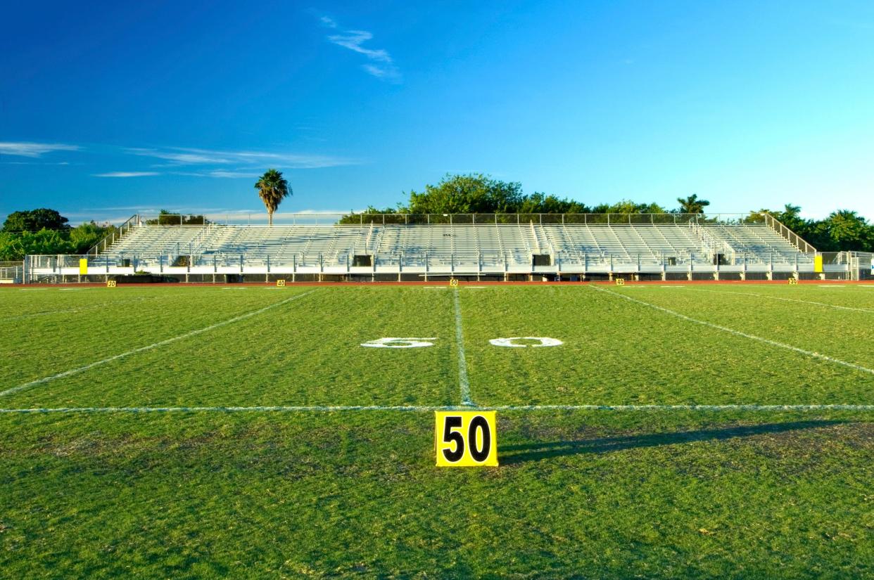 Fifty yard line marker on a high school football field.