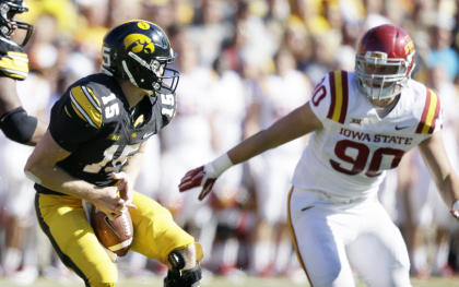 Iowa quarterback Jake Rudock, left, fumbles the ball in front of Iowa State defensive end Mitchell Meyers, right, during the first half of an NCAA college football game, Saturday, Sept. 13, 2014, in Iowa City, Iowa. Iowa State won 20-17. (AP Photo/Charlie Neibergall)