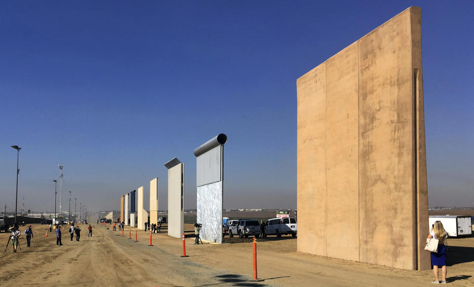 FILE - This Oct. 26, 2017 file photo shows prototypes of border walls in San Diego. In his demands that Congress set aside $5.7 billion for a border wall, President Donald Trump insists a physical barrier would stop heroin entering the U.S. from Mexico. But U.S. statistics, analysts and testimony at the trial of drug kingpin Joaquin "El Chapo" Guzman in New York show that most hard drugs entering the U.S. from Mexico come through land ports of entry staffed by agents, not open sections of the border. (AP Photo/Elliott Spagat, File)