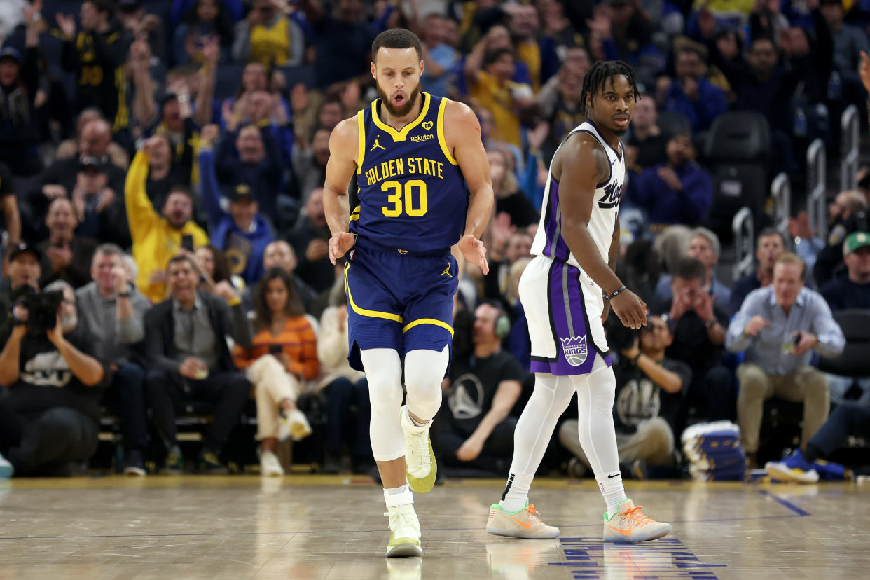 SAN FRANCISCO, CALIFORNIA - JANUARY 25: Stephen Curry #30 of the Golden State Warriors reacts after he made a three-point basket on Davion Mitchell #15 of the Sacramento Kings in the first half at Chase Center on January 25, 2024 in San Francisco, California. NOTE TO USER: User expressly acknowledges and agrees that, by downloading and or using this photograph, User is consenting to the terms and conditions of the Getty Images License Agreement.  (Photo by Ezra Shaw/Getty Images)