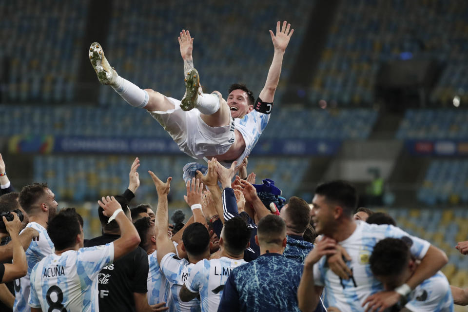 Teammates lift Argentina's Lionel Messi after beating Brazil 1-0 in the Copa America final soccer match at the Maracana stadium in Rio de Janeiro, Brazil, Saturday, July 10, 2021. (AP Photo/Bruna Prado)