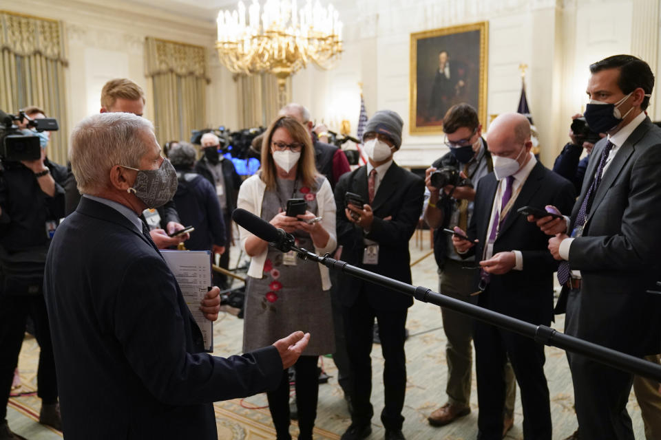 Dr. Anthony Fauci, director of the National Institute of Allergy and Infectious Diseases, talks with reporters before an event with President Joe Biden on the coronavirus in the State Dinning Room of the White House, Thursday, Jan. 21, 2021, in Washington. (AP Photo/Alex Brandon)