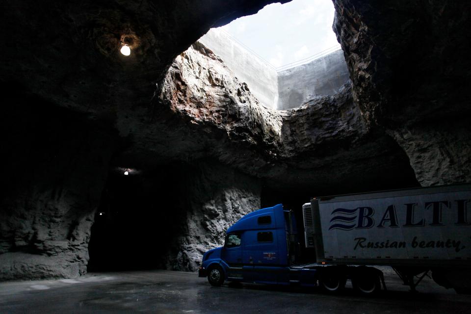 A tractor trailer passes under a large hole in the roof of the Springfield Underground, that once served as the original mining operations way to remove limestone material to the surface. The underground now houses 2.2 million square feet of storage and manufacturing space 100 feet underground.