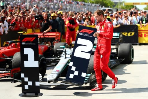 An angry Sebastian Vettel swaps the number one for the winner from in front of Hamilton's Mercedes in parc ferme
