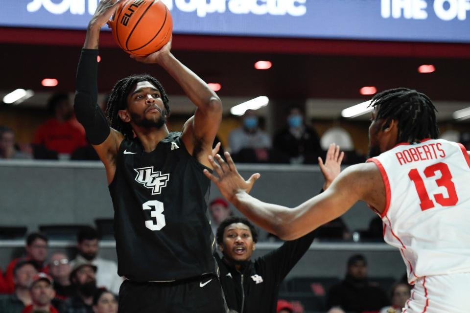 UCF forward Isaiah Adams (3) shoots the ball over Houston forward J'Wan Roberts (13) during a February game.