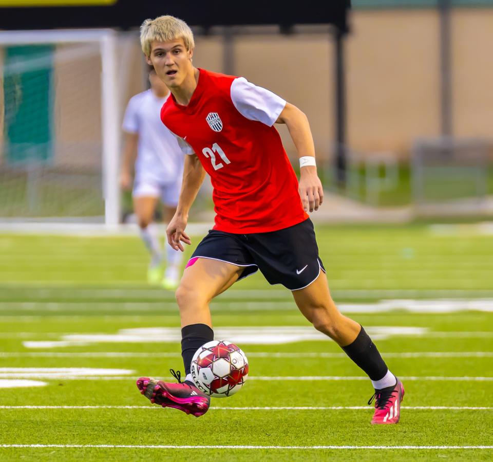 Bowie's Rowen Wells (21) looks to pass the ball against the Westlake Chaparrals during the first half at the District 26-6A boys soccer game on Friday, Feb 2, 2024, at Toney Burger Stadium in Austin, TX.