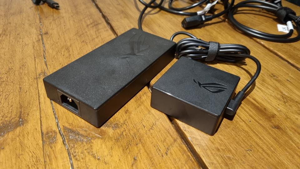 The two power bricks of the Asus ROG Zephyrus G16, one large 240W unit and one much smaller 100W unit