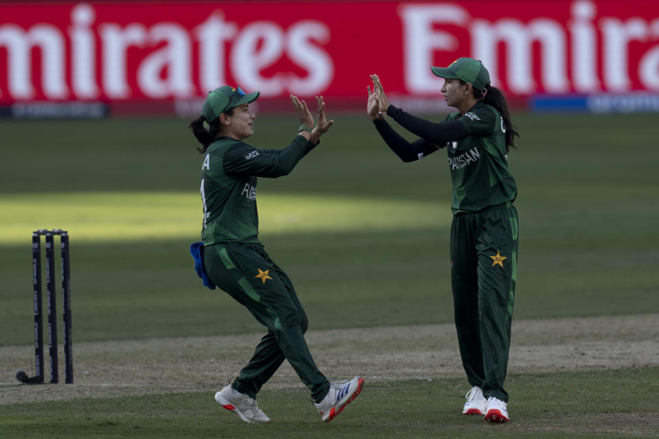 Pakistan's Omaima Sohail, right, celebrates the wicket of India's Shafali Verma with captain Fatima Sana, during the ICC Women's T20 World Cup 2024 match between Pakistan and India at Dubai International Stadium, United Arab Emirates, Sunday, Oct. 6, 2024. (AP Photo/Altaf Qadri)