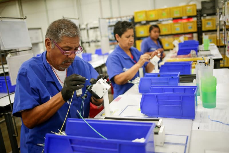 Employees work at Ark de Mexico, an assembly factory that makes wire harnesses and electric components for the automobile industry, in Ciudad Juarez