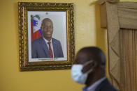 A picture of late Haitian President Jovenel Moise hangs on the wall of Haiti's Prime Minister Ariel Henry´s residence, in Port-au-Prince, Tuesday, Sept. 28, 2021. (AP Photo/Joseph Odelyn)