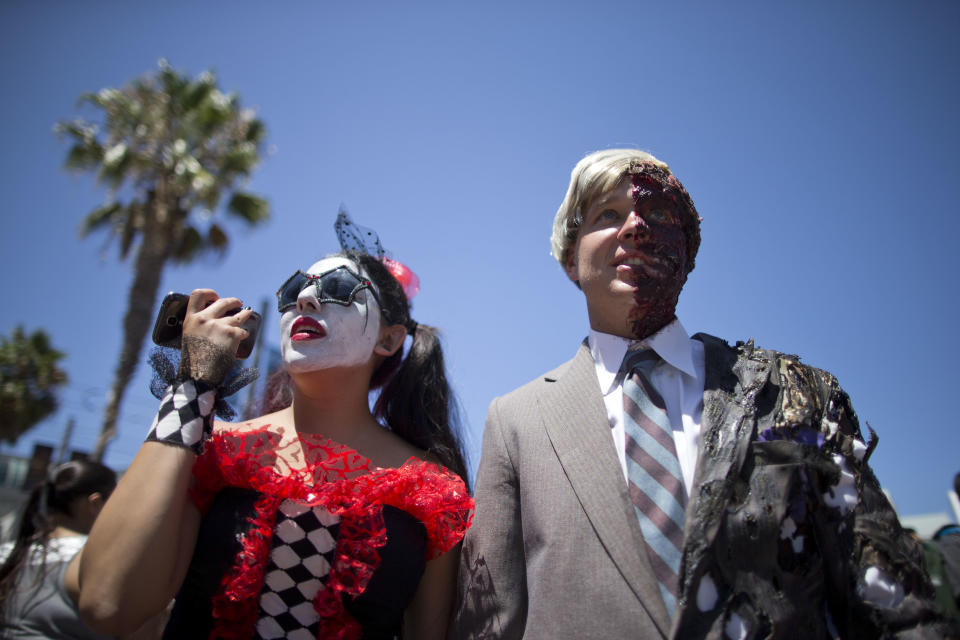 Christine and Justin Skolek walk outside during Comic-Con Thursday, July 24, 2014, in San Diego. Thousands of fans with four-day passes to the sold-out pop-culture spectacular flocked to the event Thursday, many clad in costumes. (AP Photo)