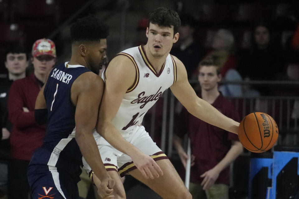 FILE- Boston College's Quinten Post, right, controls the ball during an NCAA college basketball game against Virginia, Feb. 22, 2023, in Boston. Post was the Atlantic Coast Conference's most improved player last year. (AP Photo/Charles Krupa, File)