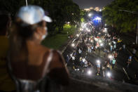 People march along Las Americas Highway to protest the LUMA Energy company in San Juan, Puerto Rico, Friday, Oct. 15, 2021. Ever since LUMA began providing service over the summer, hundreds of thousands of Puerto Ricans have had to deal with widespread blackouts for extended periods of time, voltage fluctuations and bad customer service along with an increase in pricing. (AP Photo/Carlos Giusti)