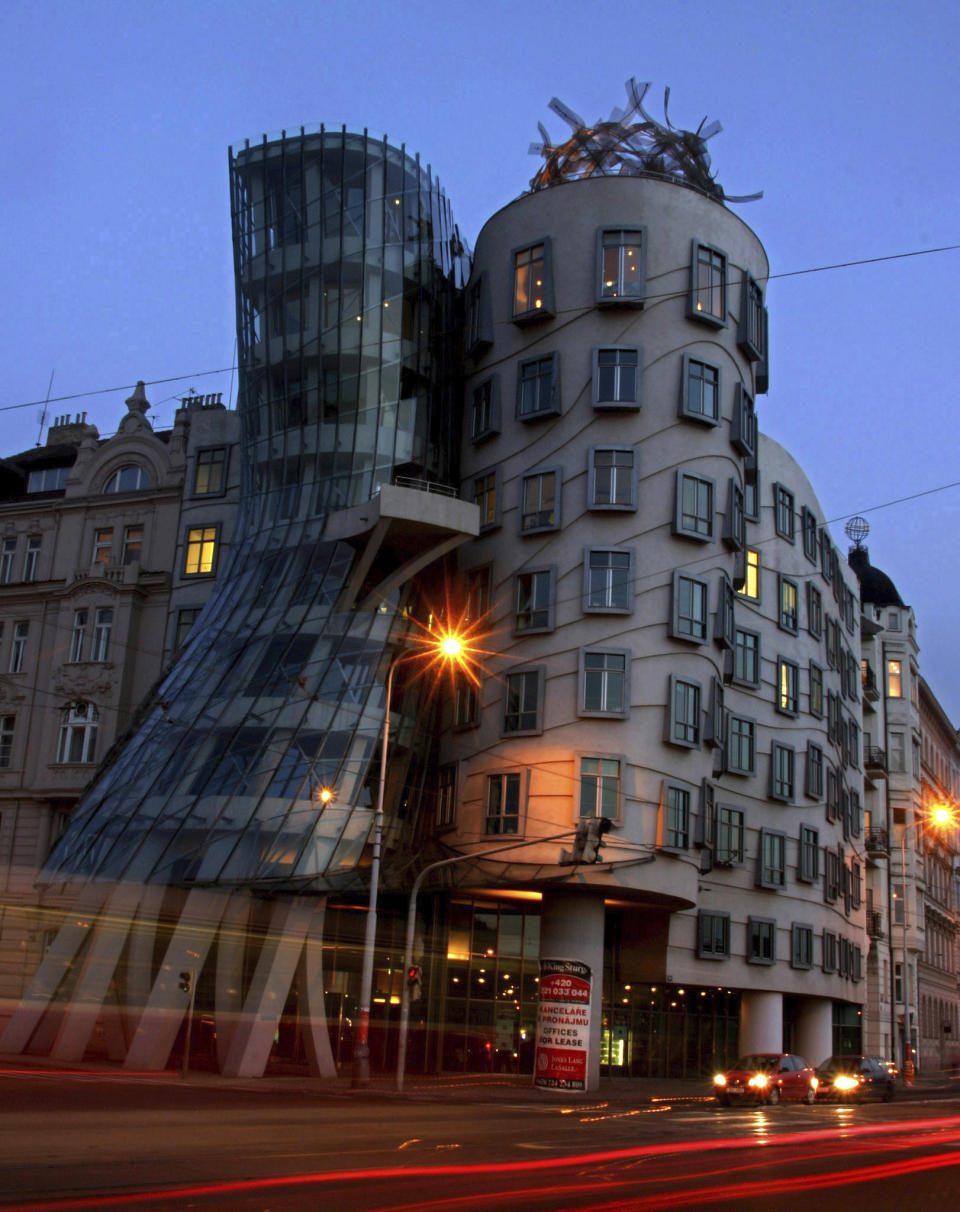 FILE- A view of the Dancing House in Prague, Czech Republic, April 3, 2004. Vlado Milunic, a Czech architect of Croatian origin, who co-designed Prague’s iconic Dancing House together with his famed colleague Frank Gehry, has died on Saturday, Sept. 17, 2022. He was 81. (AP Photo/Petr David Josek, File )