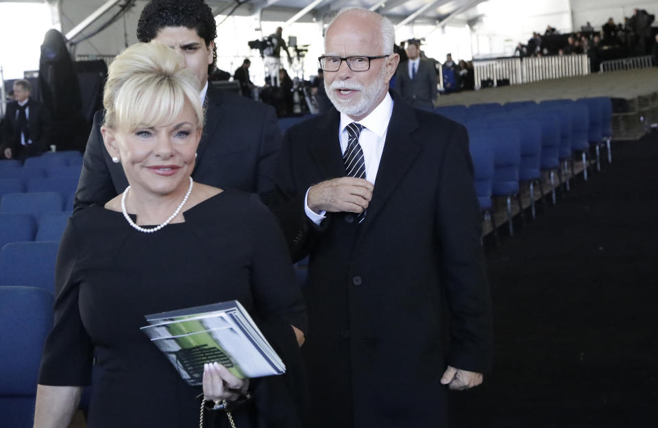 FILE - In this Friday, March 2, 2018 file photo, televangelist Jim Bakker, right, walks with his wife, Lori Graham Bakker, after a funeral service for the Rev. Billy Graham in Charlotte, N.C. During The Jim Bakker Show which aired April 20, 2020, Bakker, his wife, Lori, and daughter, Maricela Bakker Woodall, who serves as chief operating officer of Morningside Church, appealed for donations. They referenced financial difficulties, and Bakker singled out “enemies” who were behind their problems. “Don’t let me have to file for bankruptcy,” he said. (AP Photo/Chuck Burton)