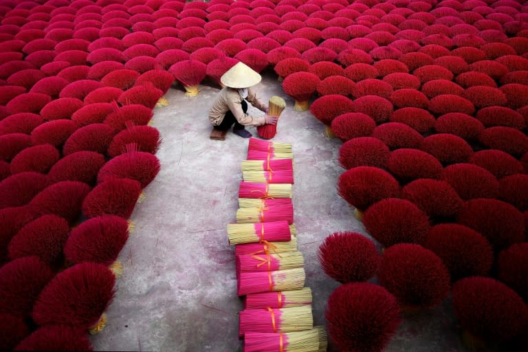 The run up to lunar new year is the most frantic time in Vietnam's 'incense village' where hundreds of workers are hard at work dying, drying and whittling down bamboo bark to make the fragrant sticks