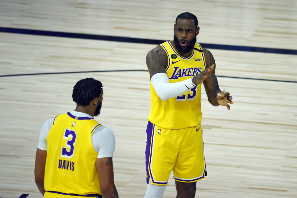 Los Angeles Lakers' Anthony Davis (3) with LeBron James (23) during the first half of an NBA basketball game against the Oklahoma City Thunder Wednesday, Aug. 5, 2020, in Lake Buena Vista, Fla. (Kevin C. Cox/Pool Photo via AP)