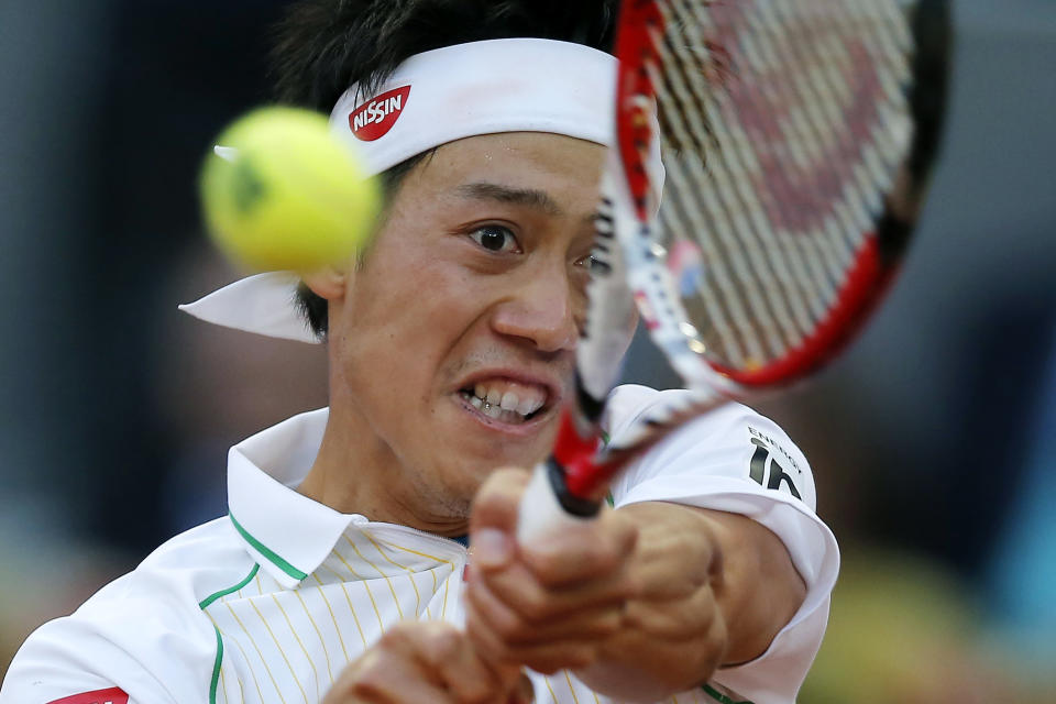 Kei Nishikori from Japan returns the ball during his Madrid Open tennis tournament final match against Rafael Nadal from Spain in Madrid, Spain, Sunday, May 11, 2014. (AP Photo/Andres Kudacki)