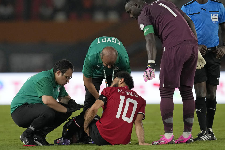 Egypt's Mohamed Salah receives medical treatment during the African Cup of Nations Group B soccer match between Egypt and Ghana in Abidjan, Ivory Coast, Thursday, Jan.18, 2024. (AP Photo/Themba Hadebe)