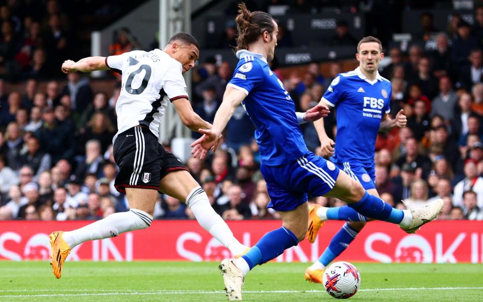 Carlos Vinicius of Fulham scores the team's second goal whilst under pressure from Caglar Soyuncu of Leicester City - Clive Rose/Getty Images