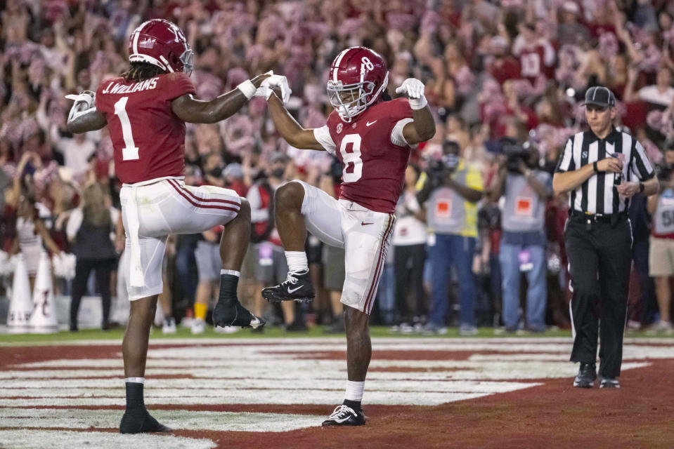 Alabama wide receivers Jameson Williams (1) and John Metchie III (8) celebrate Metchie's touchdown against Tennessee during the first half of an NCAA college football game Saturday, Oct. 23, 2021, in Tuscaloosa, Ala. (AP Photo/Vasha Hunt)