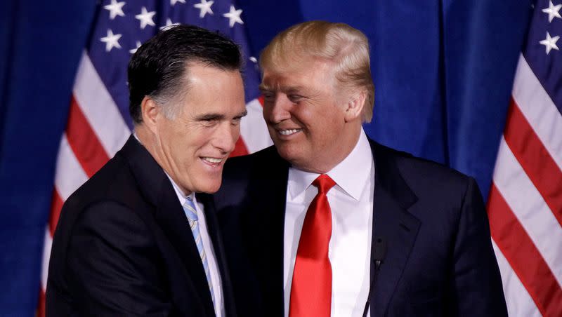 Donald Trump greets Republican presidential candidate Mitt Romney after announcing his endorsement of Romney during a news conference on Feb. 2, 2012, in Las Vegas.