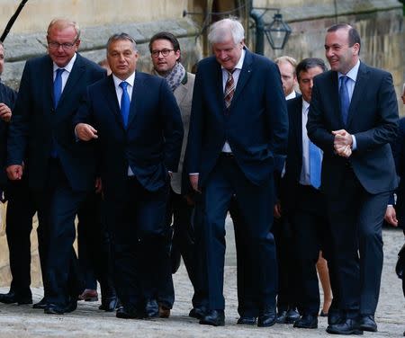 Hungarian Prime Minister Viktor Orban (2nd L) is welcomed by Bavarian state premier Horst Seehofer (2nd R) at a CSU party event in Kloster Banz near Bad Staffelstein, Germany September 23, 2015. REUTERS/Michael Dalder