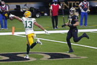 Green Bay Packers wide receiver Allen Lazard (13) gestures after a touchdown reception against New Orleans Saints middle linebacker Alex Anzalone (47) in the first half of an NFL football game in New Orleans, Sunday, Sept. 27, 2020. (AP Photo/Brett Duke)