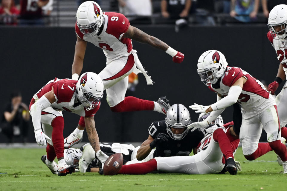 Arizona Cardinals cornerback Byron Murphy Jr., left, picks up a fumble and returns it for the winning touchdown during overtime of an NFL football game against the Las Vegas Raiders, Sunday, Sept. 18, 2022, in Las Vegas. (AP Photo/David Becker)