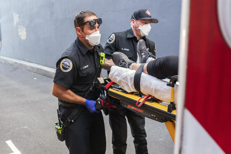 Paramedics Cody Miller, left, and Justin Jones respond to a heat exposure call during a heat wave, Saturday, June 26, 2021, in Salem, Ore. (AP Photo/Nathan Howard)