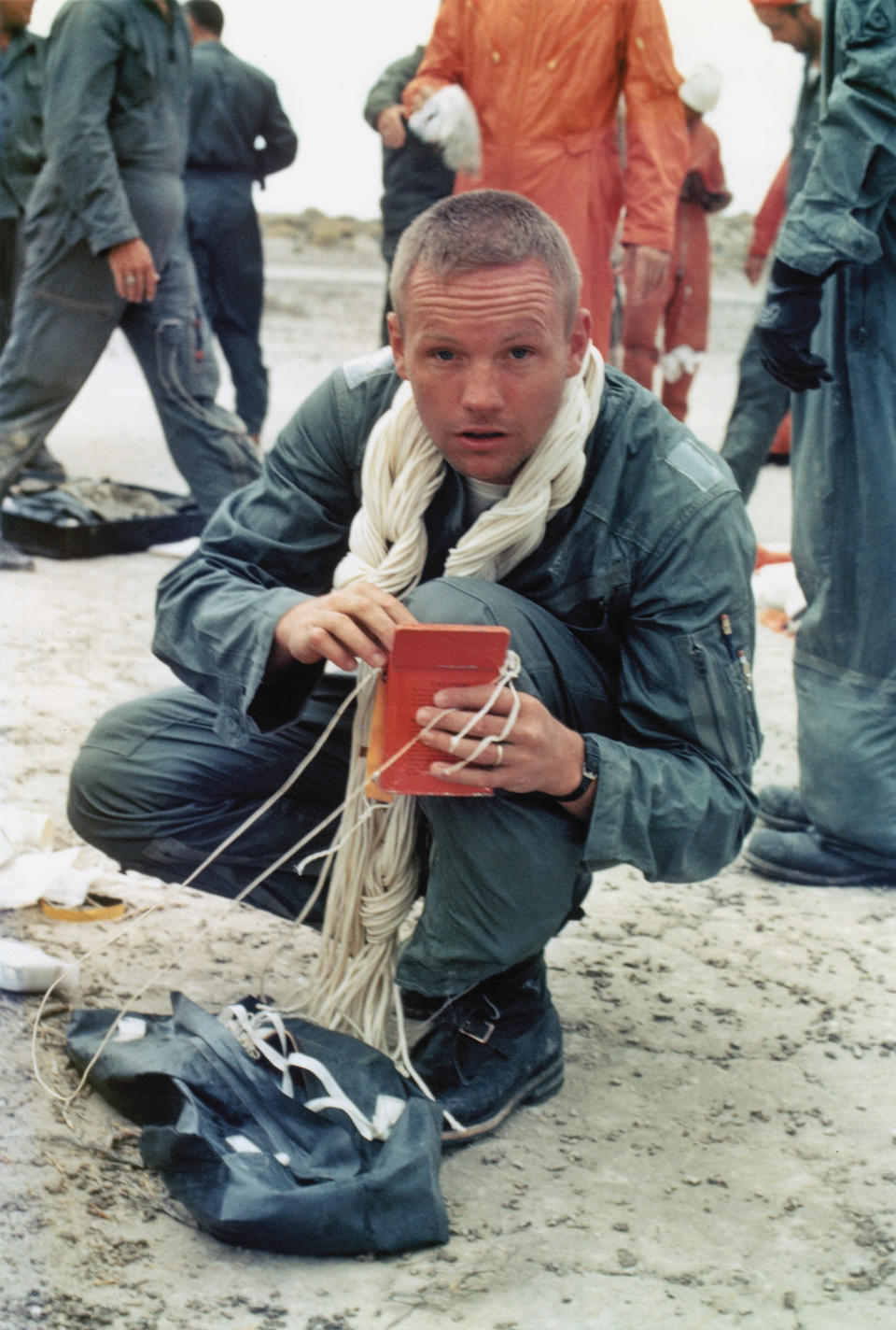 The first man on the moon Neil Armstrong, with parachute lines around his neck, undergoes desert survival training at Stead Air Force Base in northwestern Nevada on 16 August 1963. The astronauts were taught how to fabricate clothing and parachutes into survival gear in the unlikely event that their spacecraft landed in a desert. 