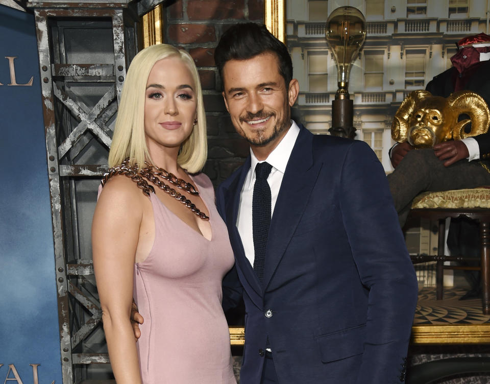 FILE - This Aug. 21, 2019 file photo shows Orlando Bloom, right, a cast member in the Amazon Prime Video series "Carnival Row," with singer Katy Perry, at the premiere of the series in Los Angeles. Perry has revealed she's pregnant at the end of the video for her latest song “Never Worn White.” The news was confirmed Thursday by Perry's label, Capitol Music Group. The baby will be Perry's first, and the second for her fiance, Orlando Bloom, who has a 9-year-old son, Flynn, with ex-wife Miranda Kerr. (Photo by Chris Pizzello/Invision/AP, File)