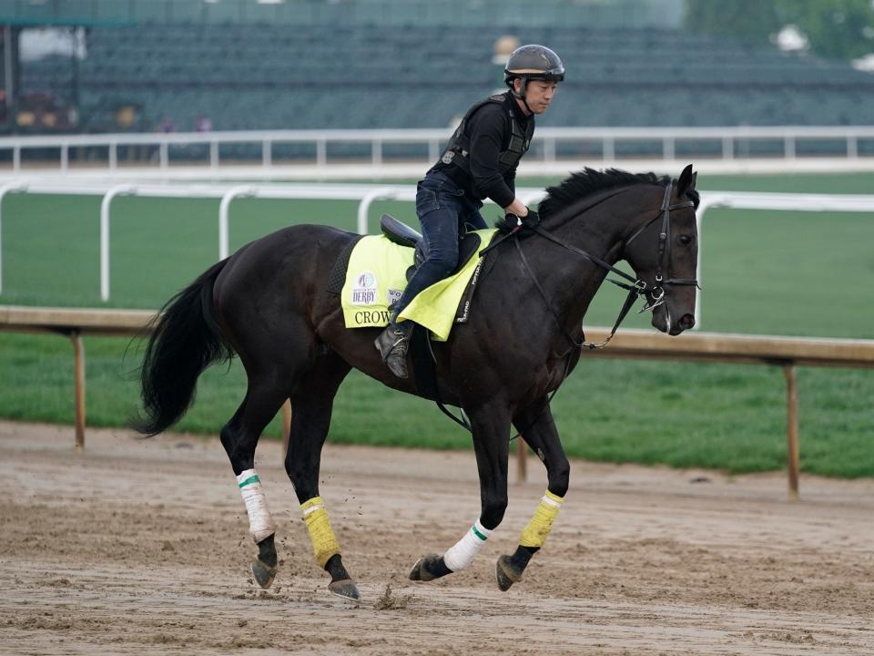 Kentucky Derby entrant Crown Pride is ridden by exercise rider Maso Matsuda during a workout at Churchill Downs.