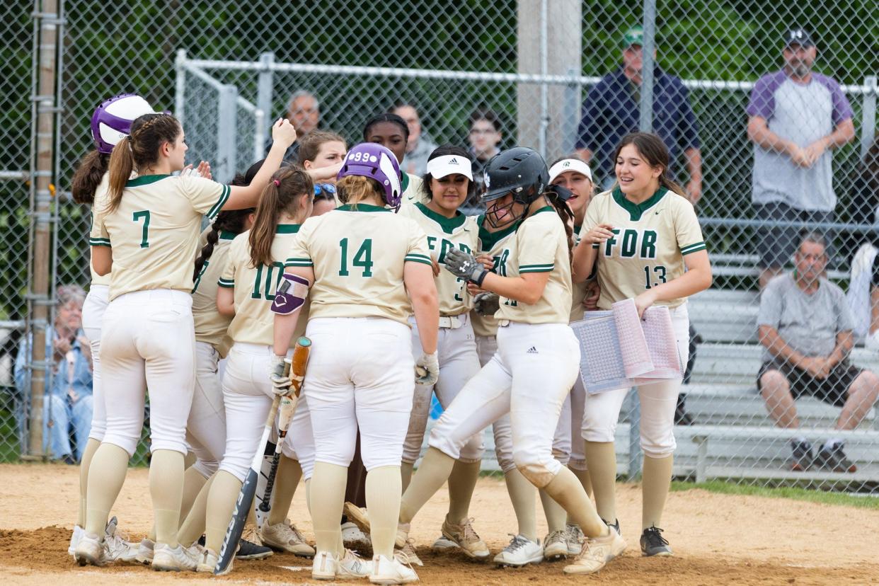 Roosevelt teammates congratulate Cali DeLawder at home plate after her home run against Minisink Valley during a May 26, 2022 softball game.