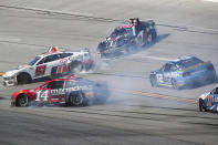 NASCAR Cup Series driver's Chase Briscoe (14), Ross Chastain (1), Ryan Blaney (12) and Justin Haley (51) spin out after a collsion during a NASCAR Cup Series auto race at Talladega Superspeedway, Sunday, April 21, 2024, in Talladega. Ala. (AP Photo/Greg McWilliams)