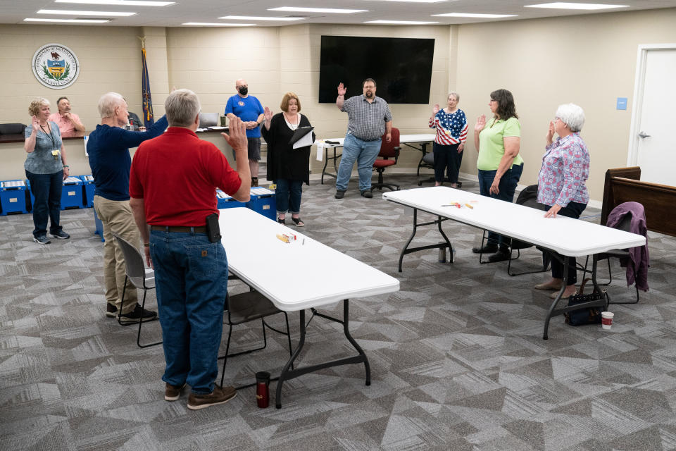 Election workers take an oath at the Montour County administration center in Danville, Pa., Friday, May 27, 2022, before performing a recount of ballots from the recent primary election. (AP Photo/Matt Rourke)