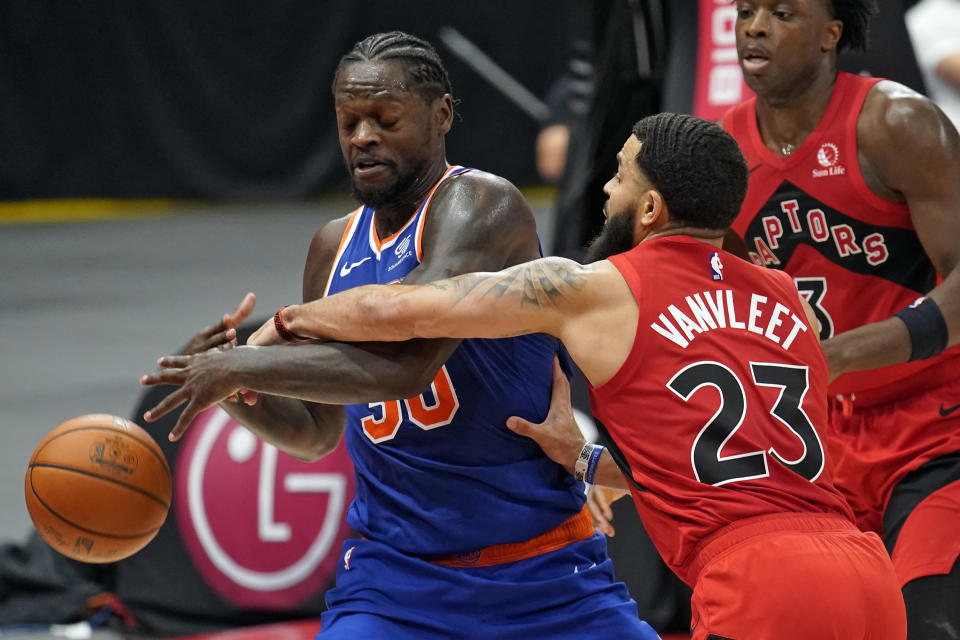 Toronto Raptors guard Fred VanVleet (23) knocks the ball away from New York Knicks forward Julius Randle (30) during the second half of an NBA basketball game Thursday, Dec. 31, 2020, in Tampa, Fla. (AP Photo/Chris O'Meara)