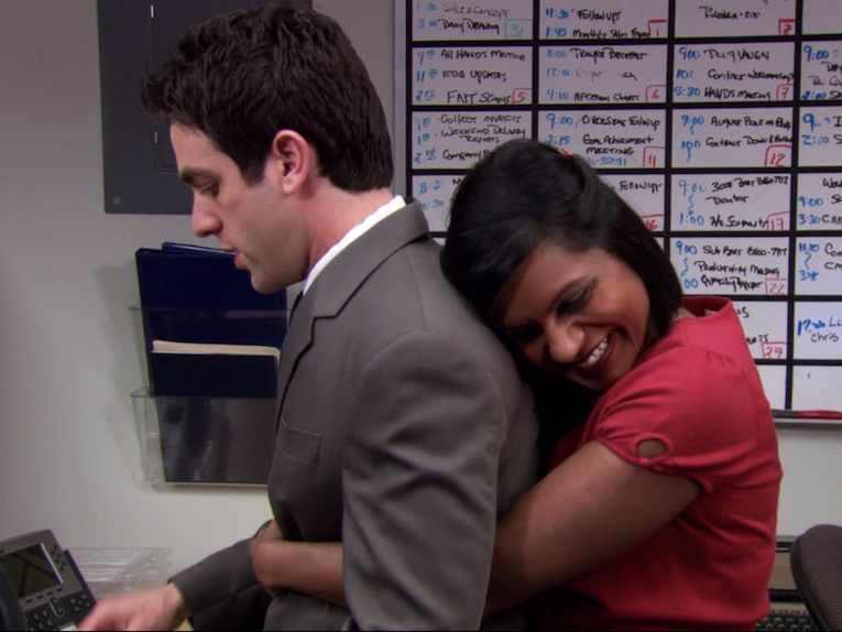 "The Office" character Kelly is seen hugging Ryan from behind, while smiling