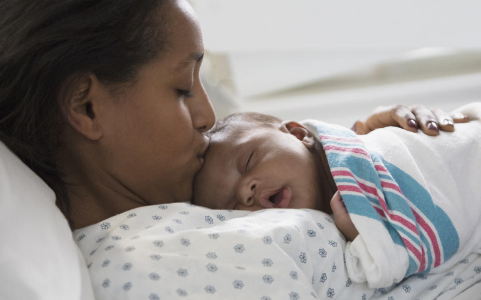 closeup of mom kissing her sleeping baby