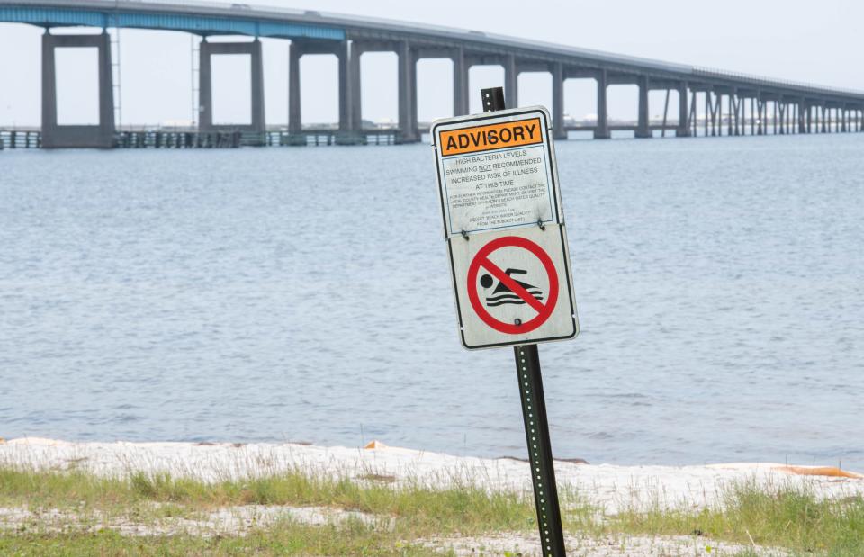 A no swimming sign is posted at Navarre Park in Navarre on Monday, Aug. 14, 2023. The Florida Department of Health in Santa Rosa County has issued a water quality advisory and advises against any water-related activities at the park due to the potential for high bacteria levels.