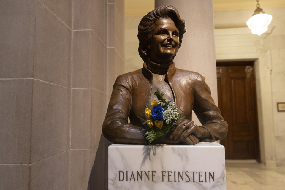 Flowers rest at a bust depicting U.S. Sen. Dianne Feinstein at City Hall in San Francisco on Friday, Sept. 29, 2023. Feinstein of California, a centrist Democrat who was elected to the Senate in 1992 in the "Year of the Woman" and broke gender barriers throughout her long career in local and national politics, has died. She was 90. (AP Photo/ Benjamin Fanjoy)