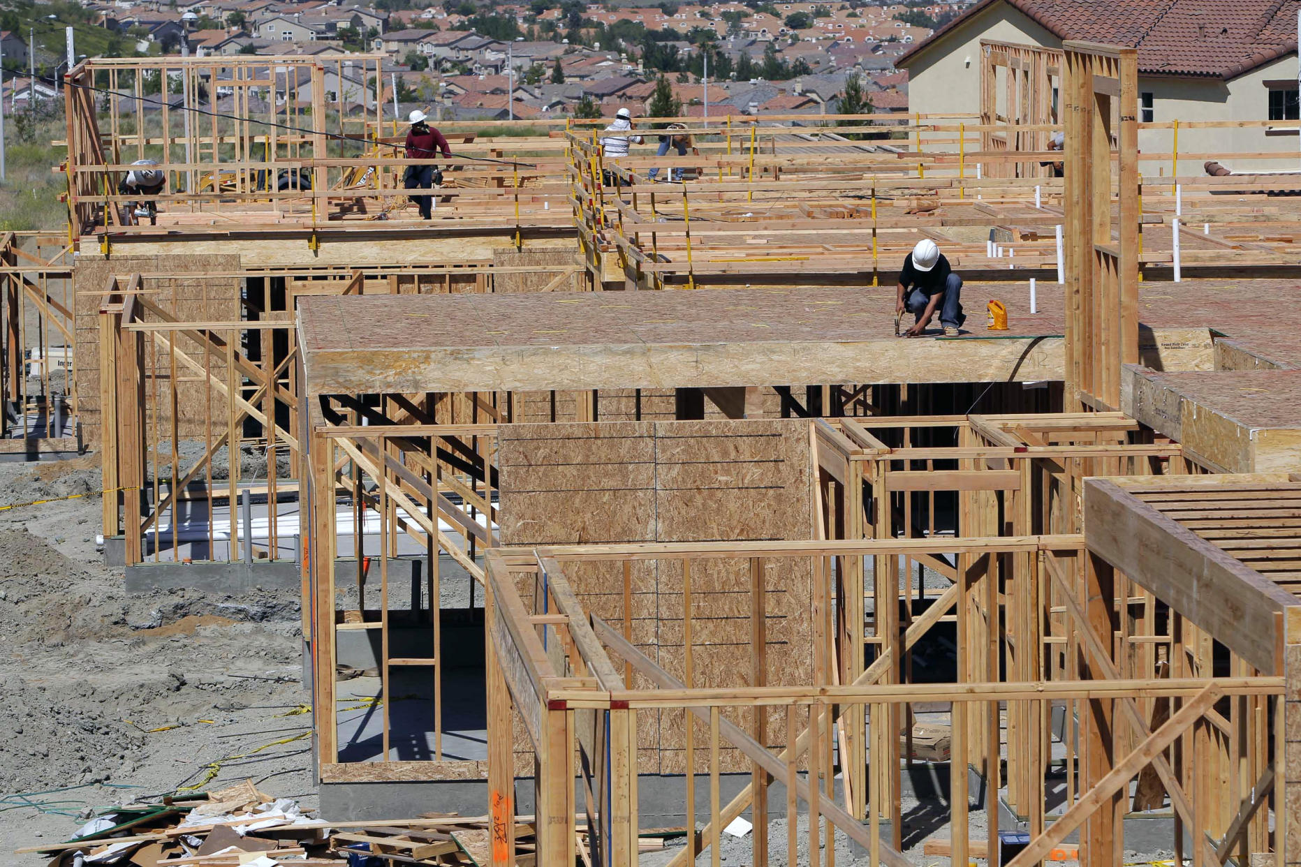 In this Wednesday, May 16, 2012, photo, construction workers frame a new house in the Crestview area in Santa Clarita, Calif. U.S. builders started work on more single-family homes in May and requested the most permits to build homes and apartments in three and a half years. The increase suggests the housing market is slowly recovering even as other areas of the economy have weakened. (AP Photo/Nick Ut)