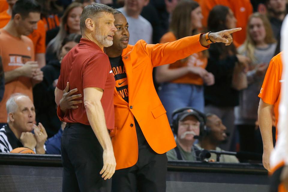 Oklahoma Sooners head coach Porter Moser and Oklahoma State Cowboys head coach Mike Boynton talk before a men's Bedlam college basketball game between the Oklahoma State University Cowboys (OSU) and the University of Oklahoma Sooners (OU) at Gallagher-Iba Arena in Stillwater, Okla., Wednesday, Jan. 18, 2023. 