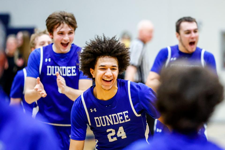 Braiden Whitaker (24) and his Dundee teammates celebrate 46-40 victory over Ida in the finals of the Division 2 District at Airport on Friday, March 1, 2024.