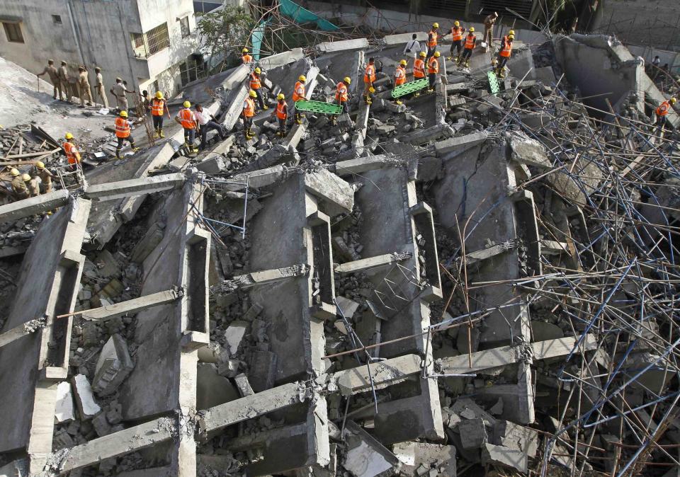 Rescue workers conduct a search operation for survivors at the site of a collapsed 11-storey building that was under construction on the outskirts of Chennai