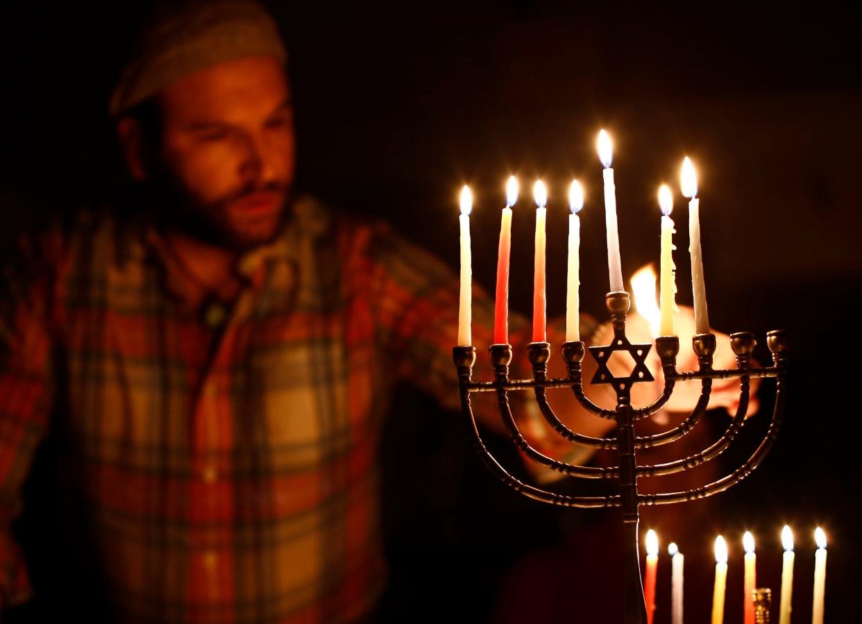 Bryan Finkelstein, of Columbus, lights Hanukkah candles at Congregation Tifereth Israel, 1354 East Broad St., as part of  an evening event entitled "Do It Yourself Judaism" on Thursday, December 29, 2016, the sixth day of Hanukkah. Rabbi Alex Braver led the event where participants learned about Hanukkah, its rituals, and its meanings,  and also learned how to make latkes, potato pancakes.