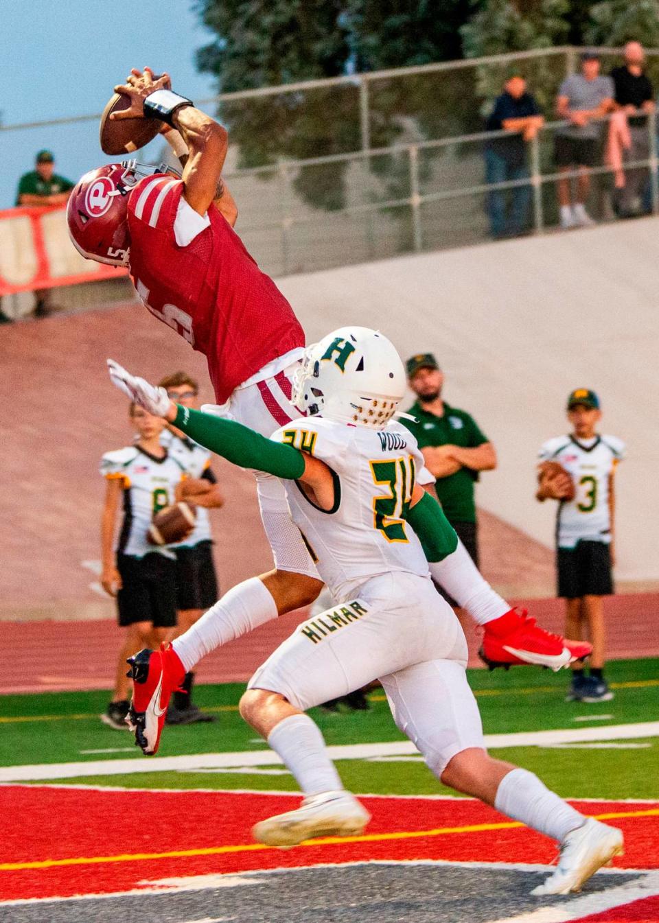 Dj Hardin, 5, of Patterson makes a touchdown catch in the end zone as Caden Wood, 24, of Hilmar defends.
