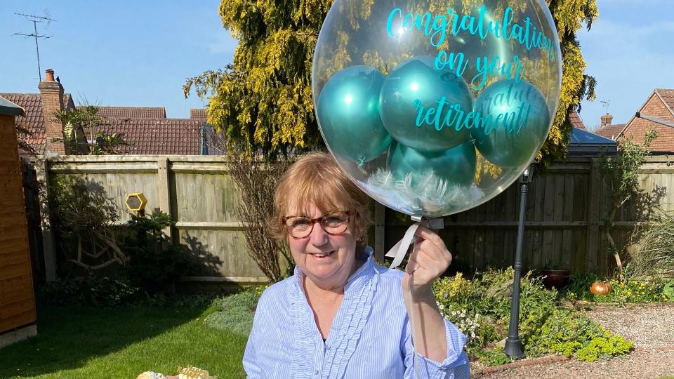 woman holding a retirement balloon