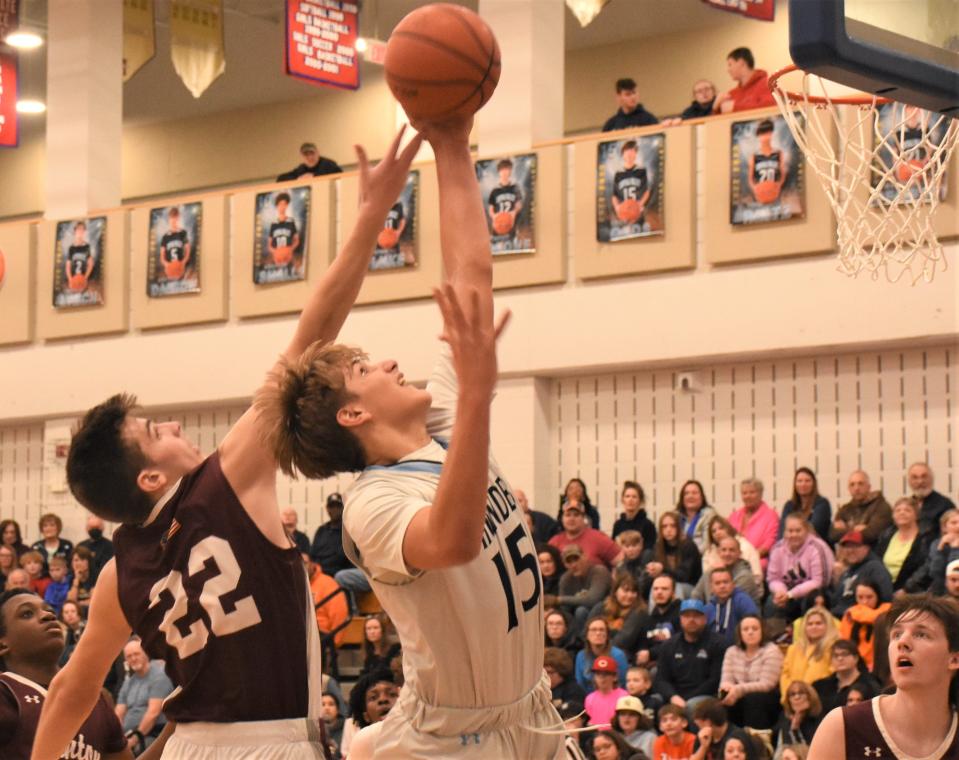 Deacon Judd (15) grabs a rebound for unbeaten Central Valley Academy in front of Clinton Warrior Jack Palmeri during Thursday's Section III quarterfinal playoff game.